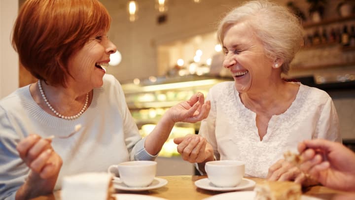 Residents laughing over teat at Brightwater Senior Living