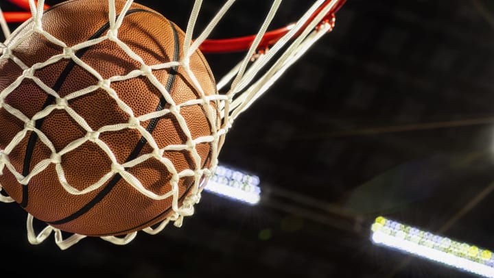Basketball going through a basketball net 