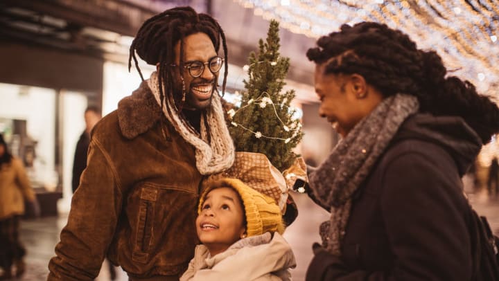 Family of three shopping at a local mall during the holidays 