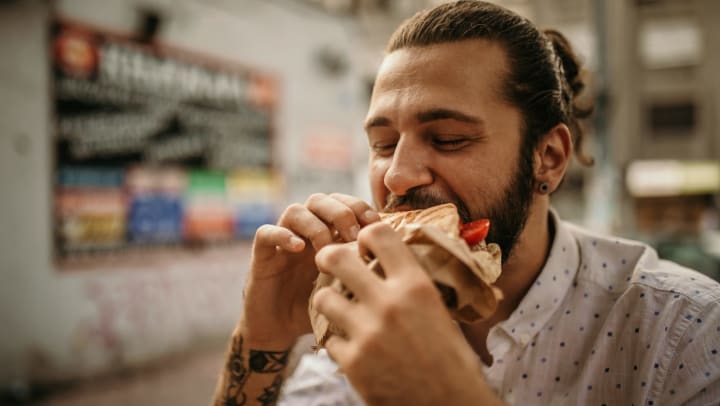 A man eating a large sandwich