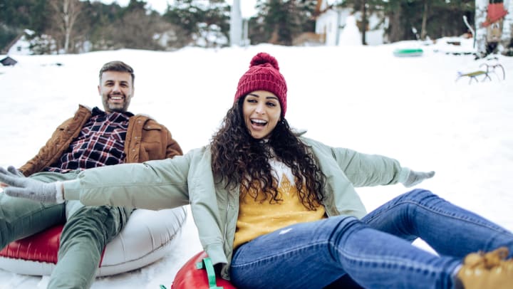 People sledding down a mountain