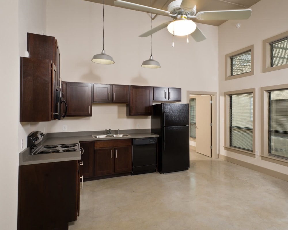 Kitchen with black appliances at Gold Seal Lofts in New Orleans, Louisiana