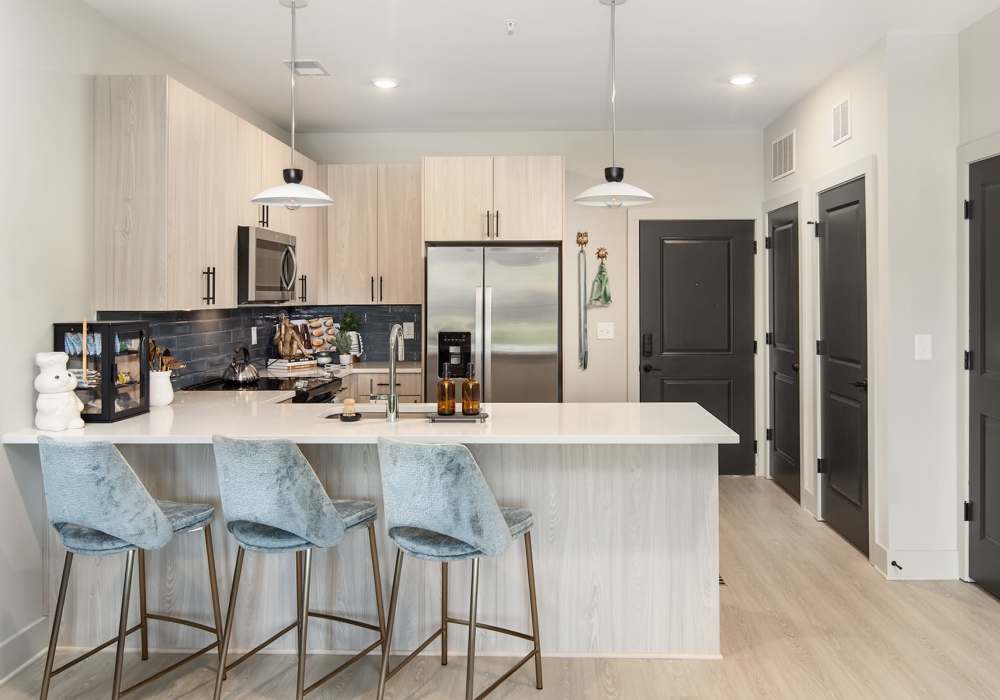 Kitchen with stainless-steel sink in modern apartment home at Cypress Point in Mooresville, North Carolina.