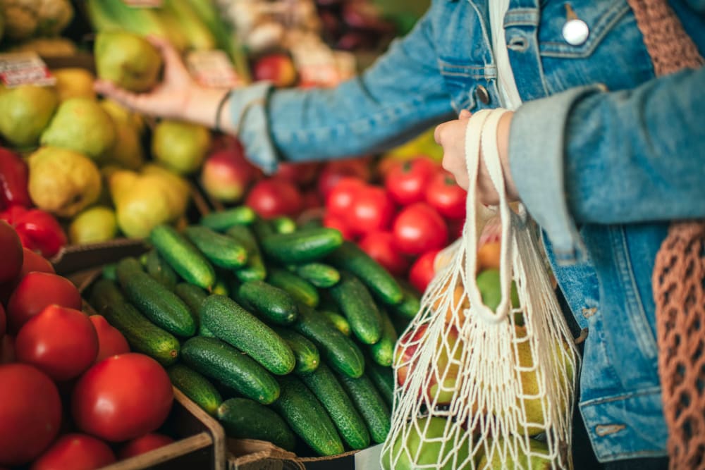 A woman shopping for produce in a store near Mariposa at River Bend in Georgetown, Texas