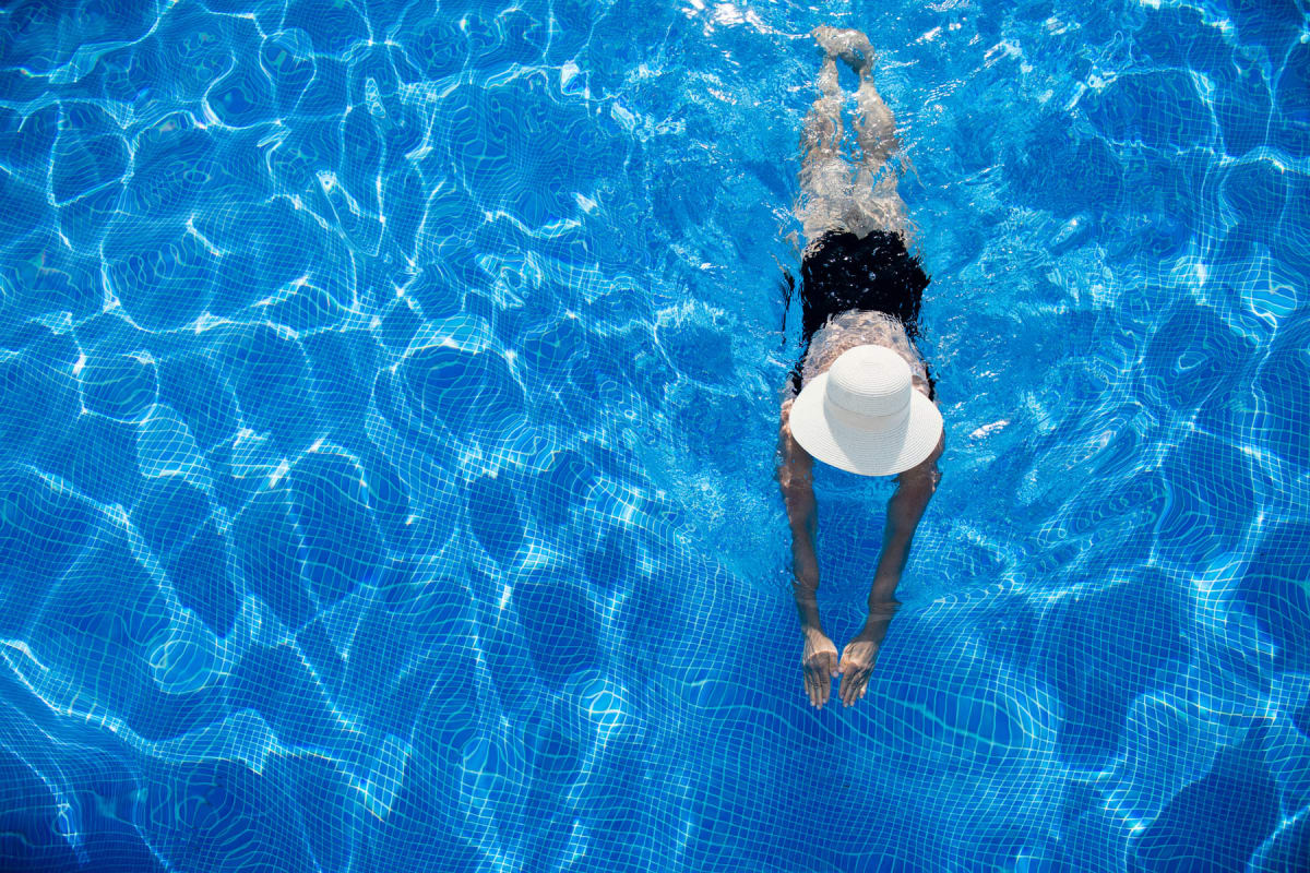 Aerial view of a resident swimming laps in the pool at Amira Bloomington in Bloomington, Minnesota