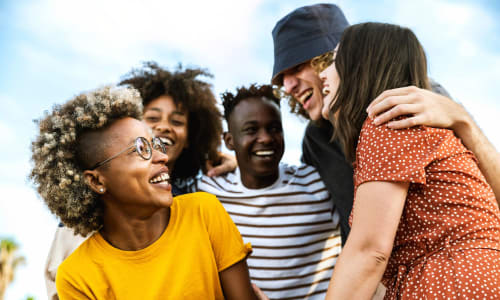 Friends laughing outside at Washington Townhomes in San Lorenzo, California