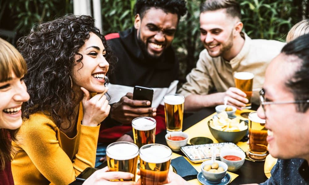 Friends out having beers near The Village at Stetson Square in Cincinnati, Ohio