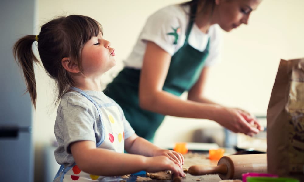 Daughter helping mom make cookies at Catalina Crest Apartment Homes in Livermore, California