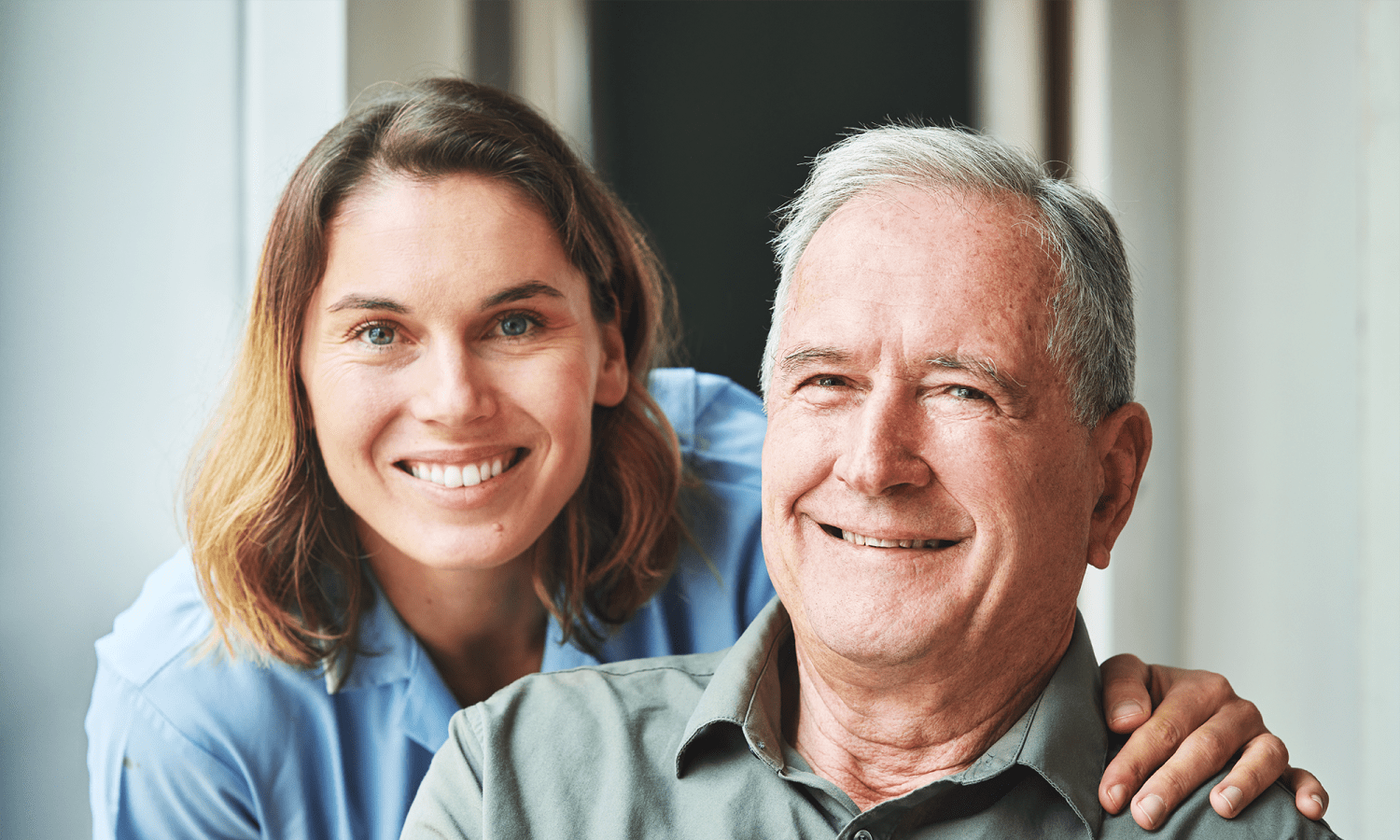 Resident and a caretaker smiling for a photo at The Manor at Market Square in Reading, Pennsylvania