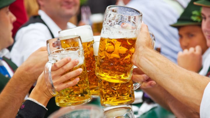 People clanging together full beer steins 