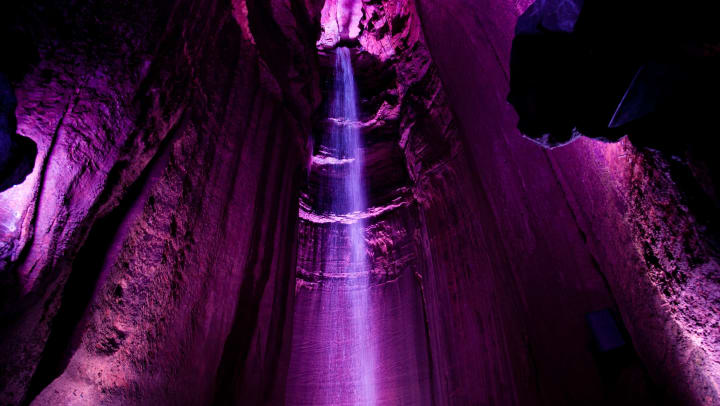 Dramatic lighting illuminates an underground waterfall in Chattanooga, Tennessee