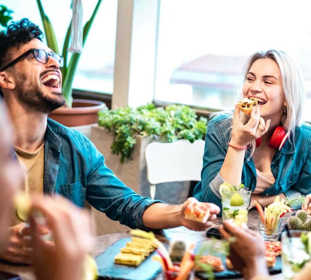 Residents enjoying appetizers and drinks togetherat Titan Court in Eugene, Oregon