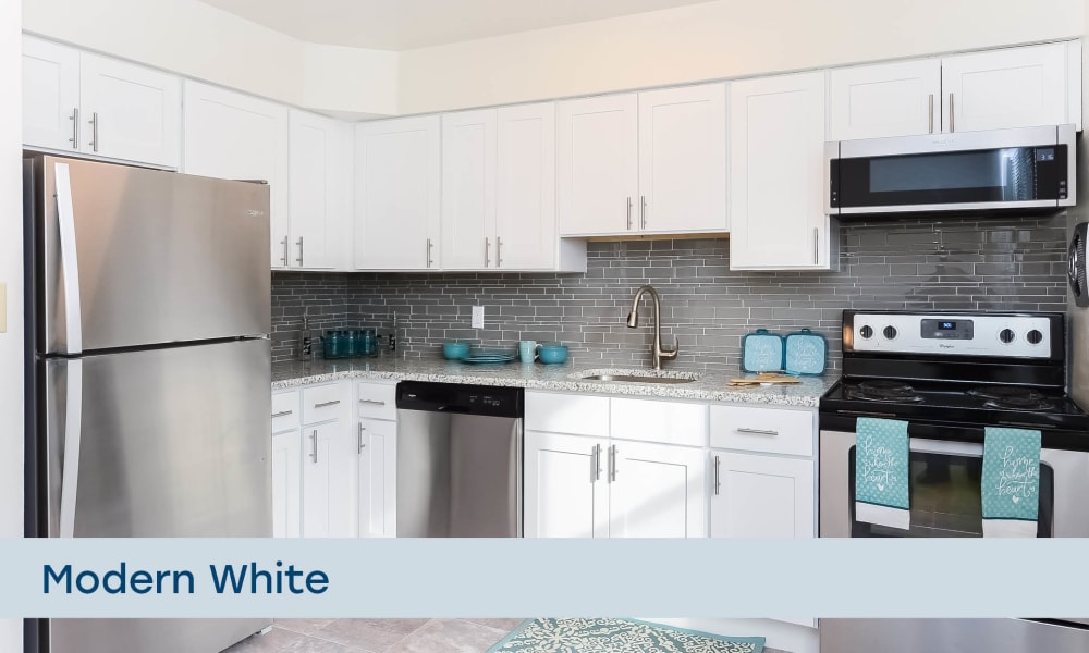 Modern kitchen with white cabinetry at Eatoncrest Apartment Homes in Eatontown, New Jersey