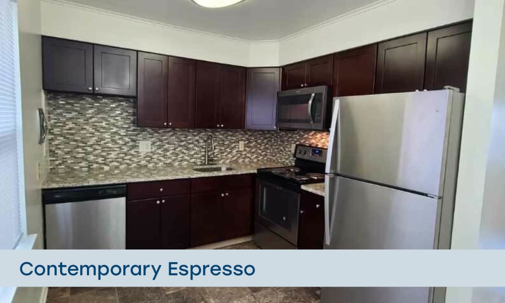 Fully equipped kitchen with contemporary espresso cabinetry at Eatoncrest Apartment Homes in Eatontown, New Jersey