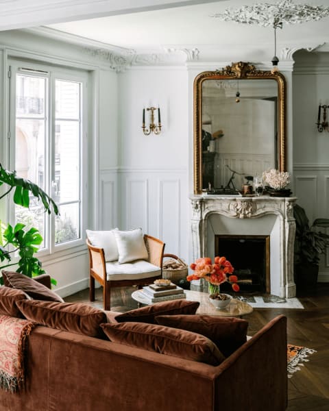 The gold ornate mirror gives that vintage element in this living room