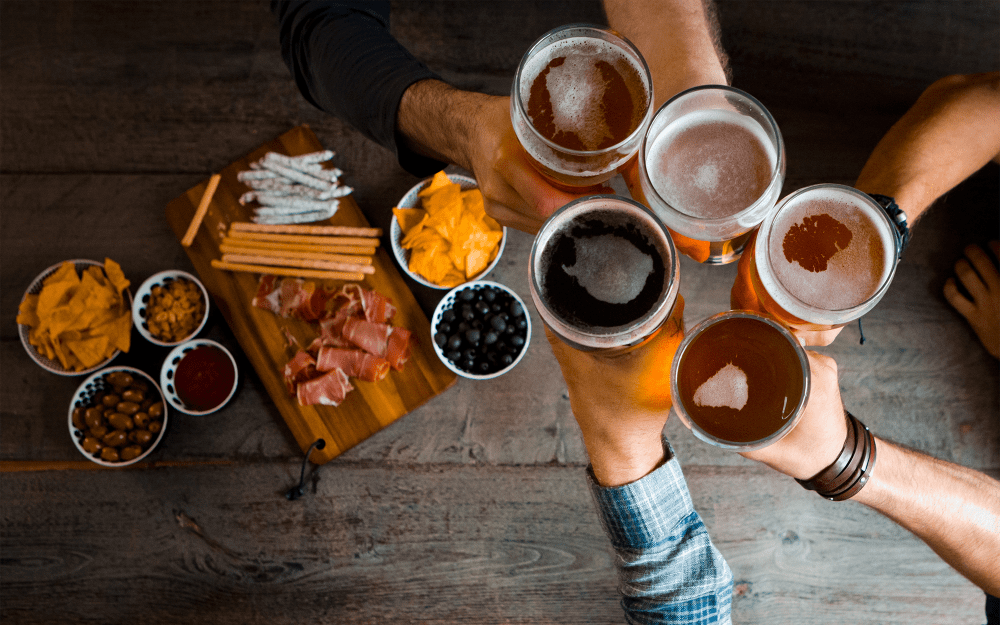 Friends enjoying craft beers and charcuterie near Top Field Apartment Homes in Cockeysville, Maryland