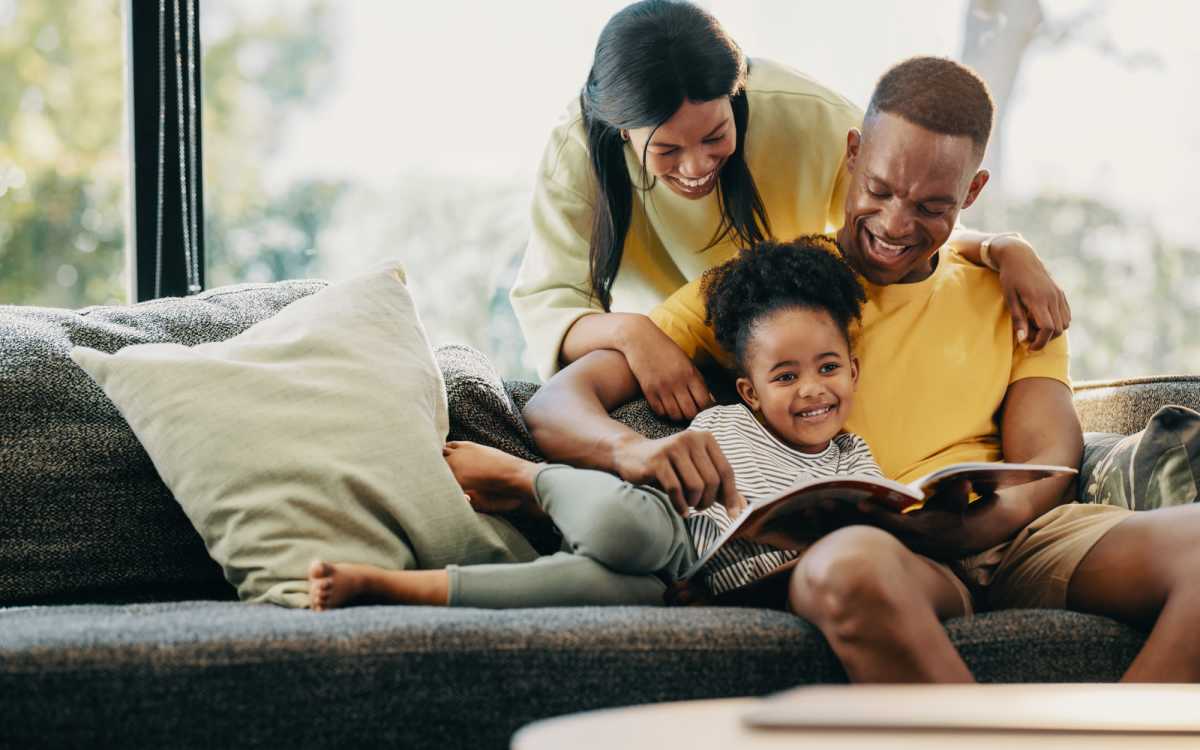 Residents reading book in luxuries living room at Renton Sage in Renton, Washington