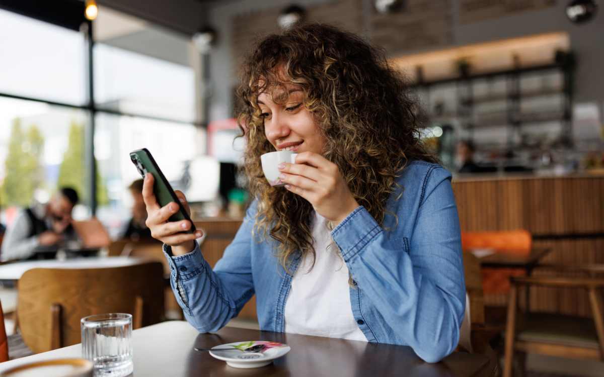 Woman having coffee at a cafe near Benton in Dallas, Texas, 