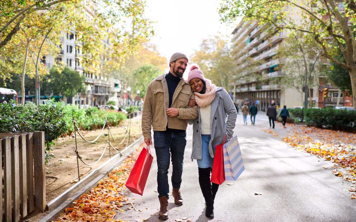 Residents walking with shopping bags in the neighborhood at High Street Lofts in Petersburg, Virginia