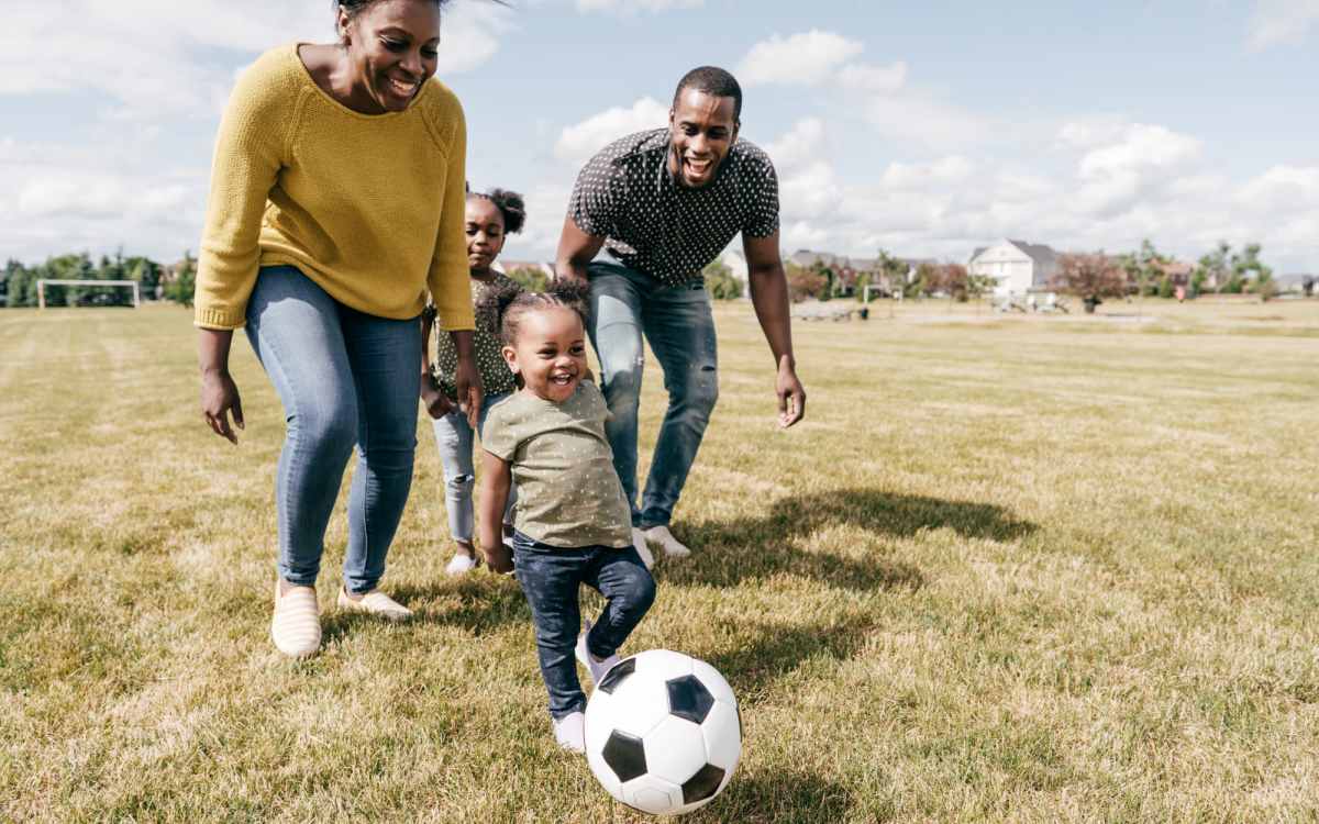Resident family playing football in the ground near The Falgrove Apartments in Omaha, Nebraska