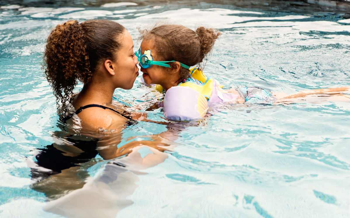 Mother and daughter in the community pool at Pelican Isles Apartments in Sebastian, Florida