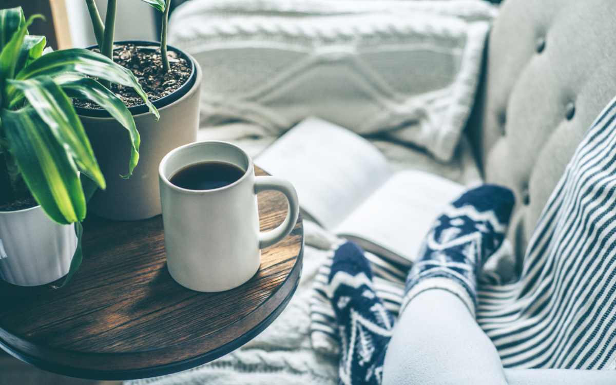 Close-up of end table with an open book and tea at Howe in Sacramento, California