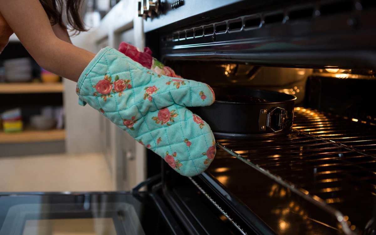 Resident using the stove at Haverstock Hills in Houston, Texas