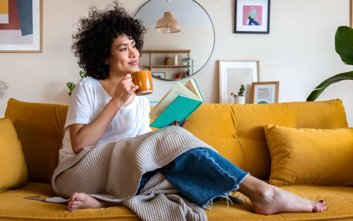 Resident having coffee while seating in her living room at Maplewood Court in Bridgeport, Connecticut