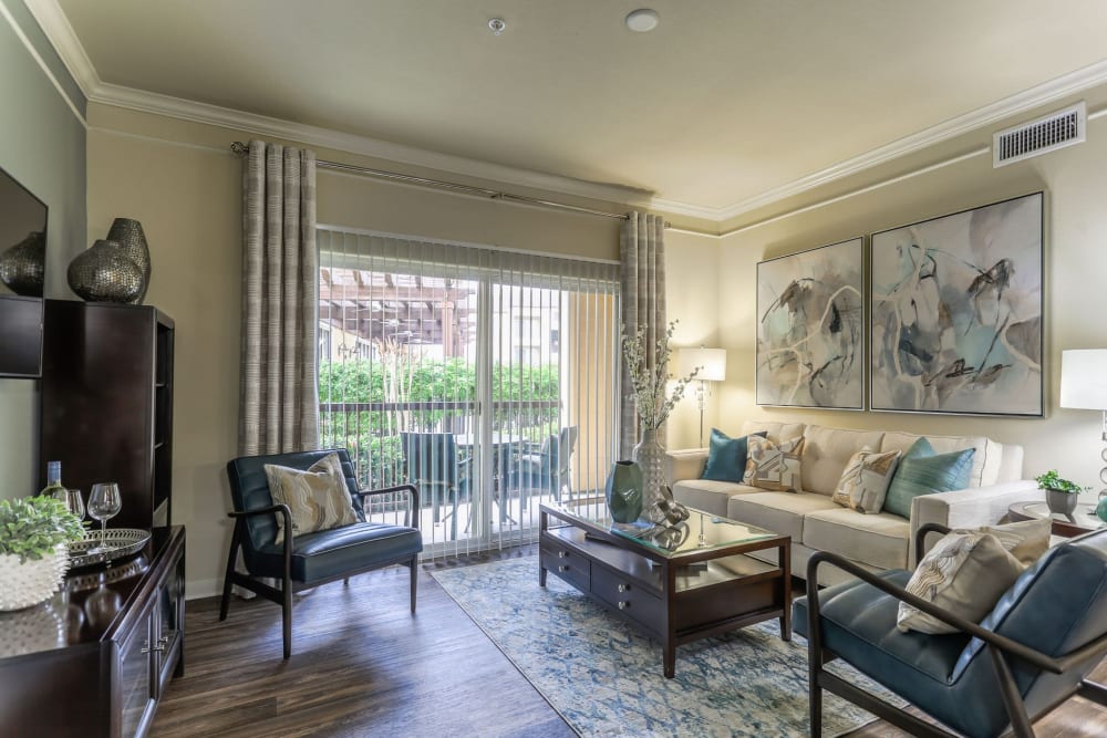 Well-furnished living space in an open-concept model home at Amalfi at Tuscan Lakes in League City, Texas