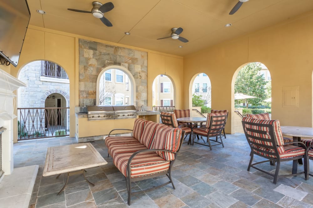Resident clubhouse lounge with a fireplace and seating at Amalfi at Tuscan Lakes in League City, Texas