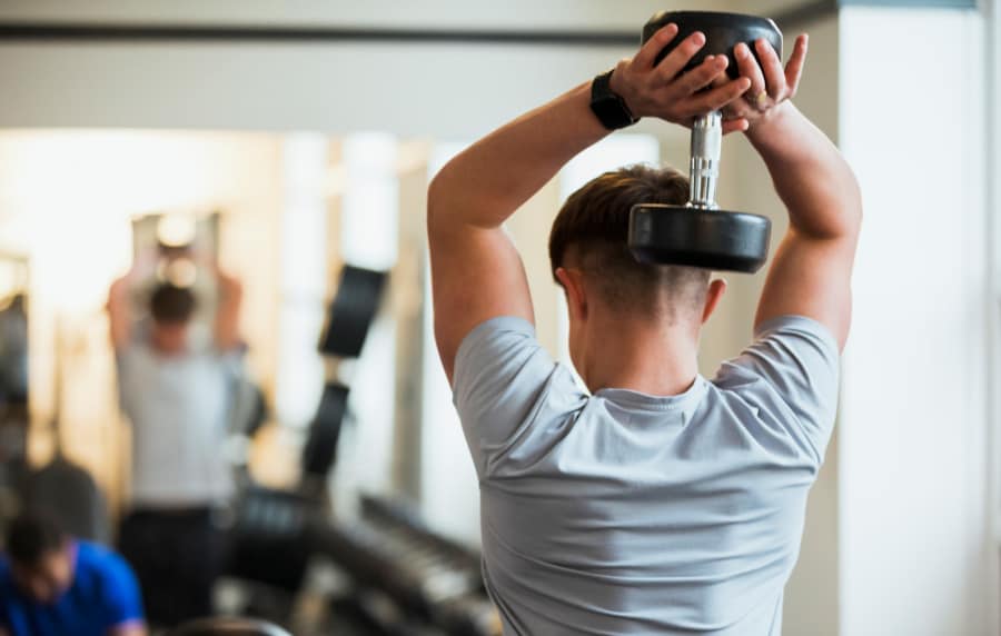 Resident lifting weights in the gym at Cypress Point in Mooresville, North Carolina