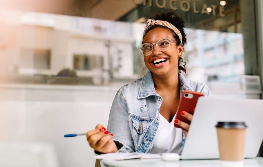Resident working outside on her laptop near UCA Apartment Homes in Fullerton, California