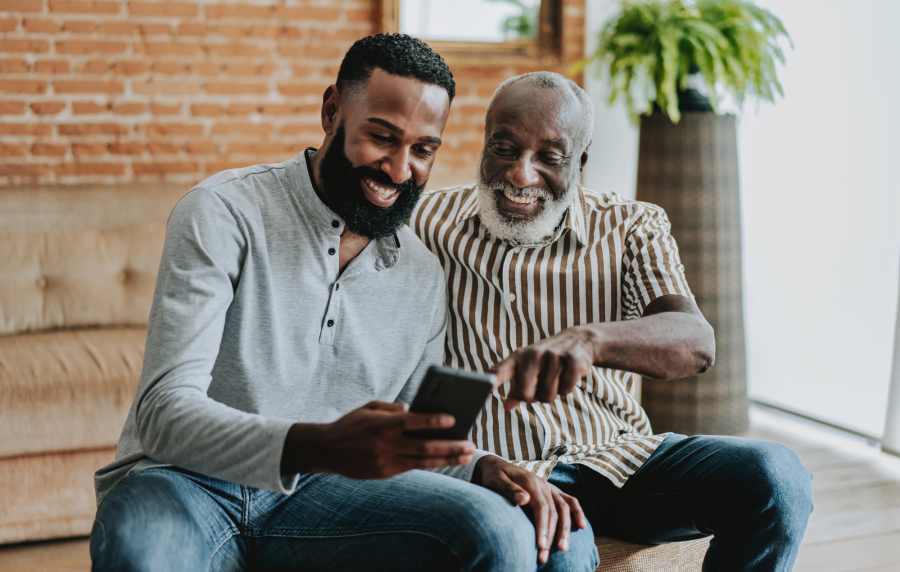Resident with his son using mobile near Cabrillo Apartments in Scottsdale, Arizona