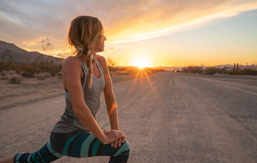 Woman doing yoga in the sunset at Cabrillo Apartments in Scottsdale, Arizona