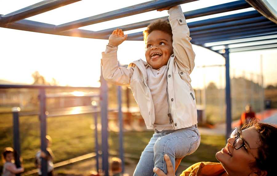 Woman and her child playing in a park near Maple Leaf Apartments in Merrillville, Indiana