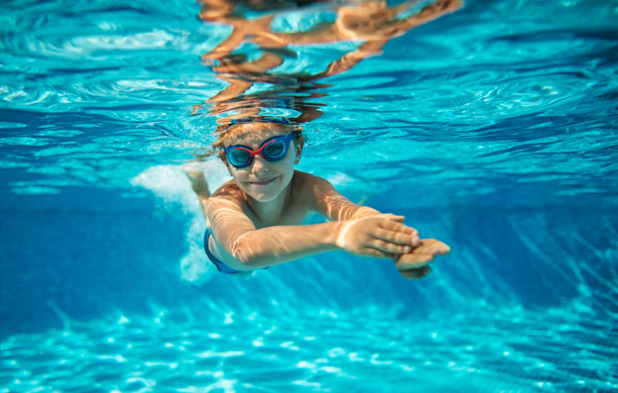 Resident kid enjoying in swimming pool at Cypress Point in Mooresville, North Carolina