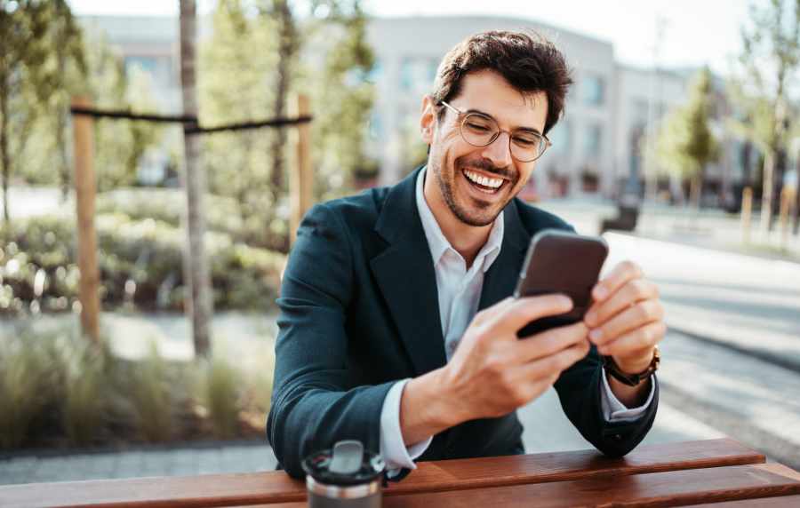 Man looking at the mobile in the neighborhood at Standard at Royal Lane in Dallas, Texas