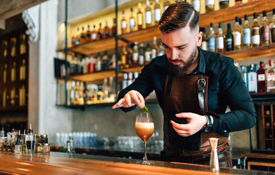 Man making drink in the restaurant near Crystal Commons Townhomes in Gates, New York