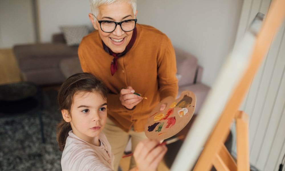 A resident and child painting at Amaran Senior Living in Albuquerque, New Mexico. 