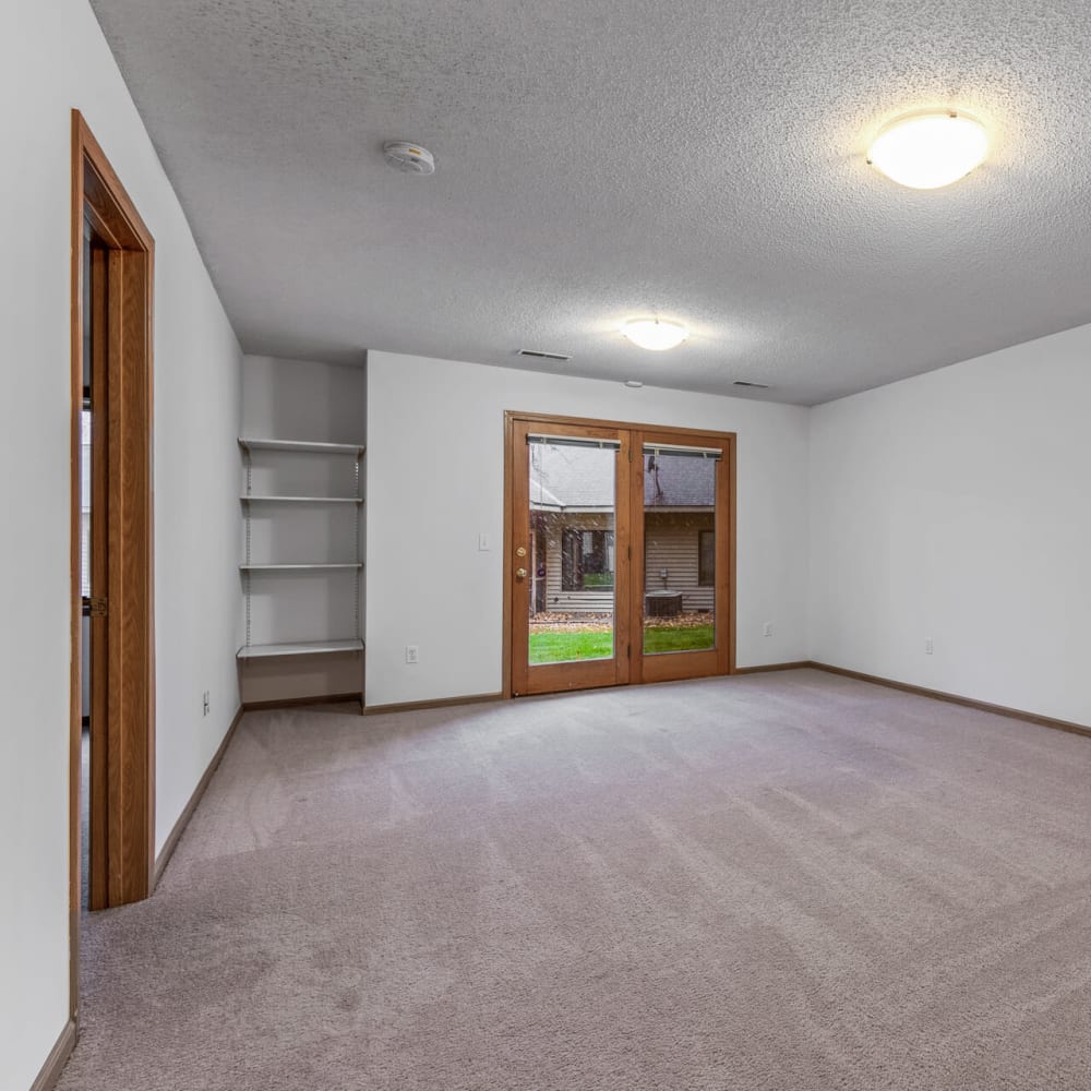 Spacious living area with  plush carpeting in a townhome at Oaks Lincoln Apartments & Townhomes in Edina, Minnesota