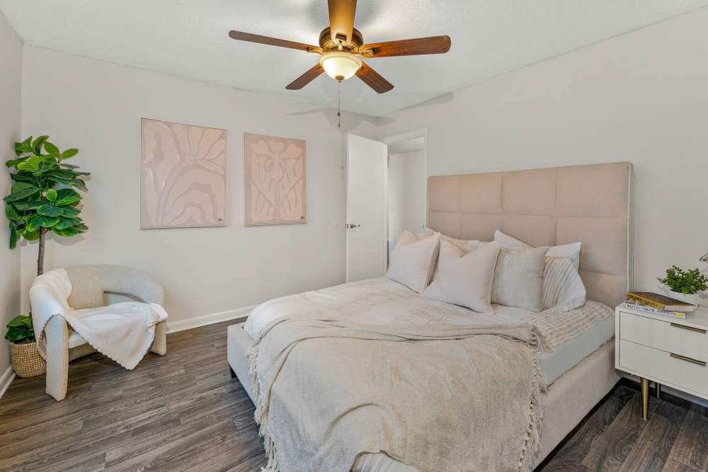 Interior View Of A Bedroom With A Neutral Color Palette, A Upholstered Bed, And Minimalist Decor at The Palms at Casselberry in Casselberry, Florida