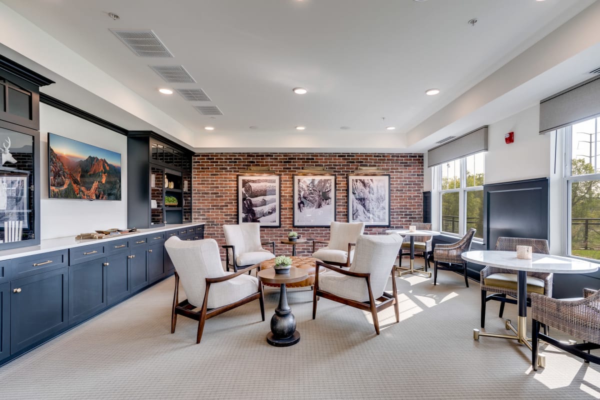 Living room with a while couch, art on the wall, and a brown wooden coffee table at Amira Roseville in Roseville, Minnesota