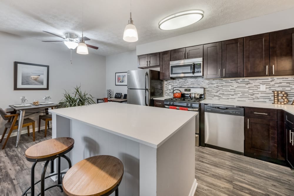 An apartment kitchen with an island at Fox and Hounds Apartments in Columbus, Ohio
