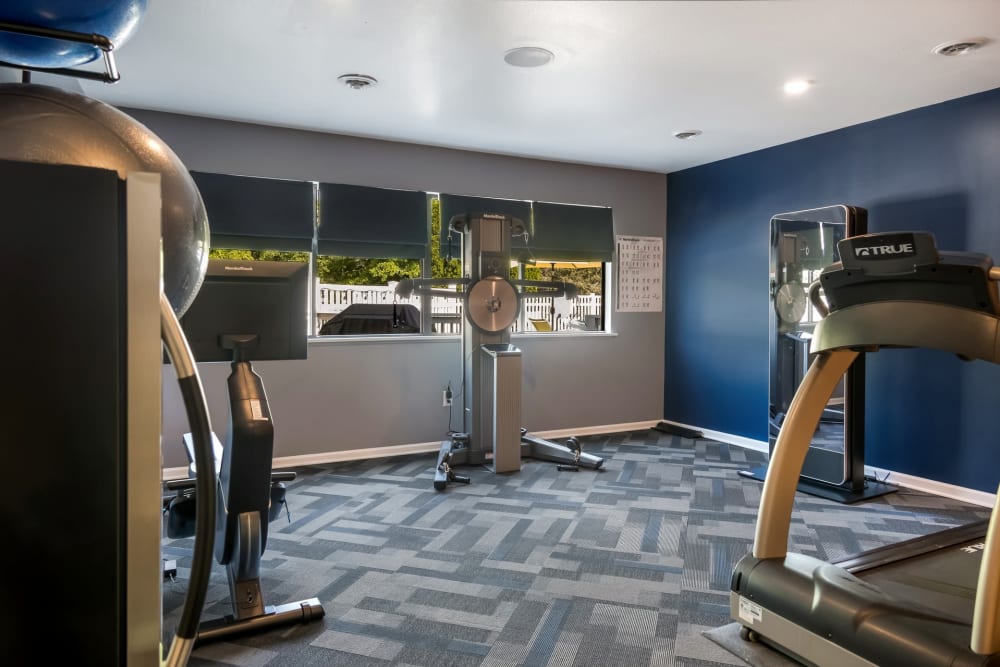 Fitness center with a variety of workout equipment at Waters Edge Apartments in Lansing, Michigan