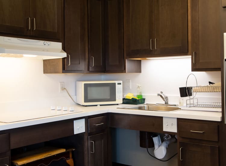 Kitchen with modern appliances at Chelsea Village in Chelsea, Massachusetts