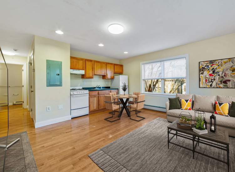 Living room with view to kitchen at One Neighborhood Builders in Providence, Rhode Island