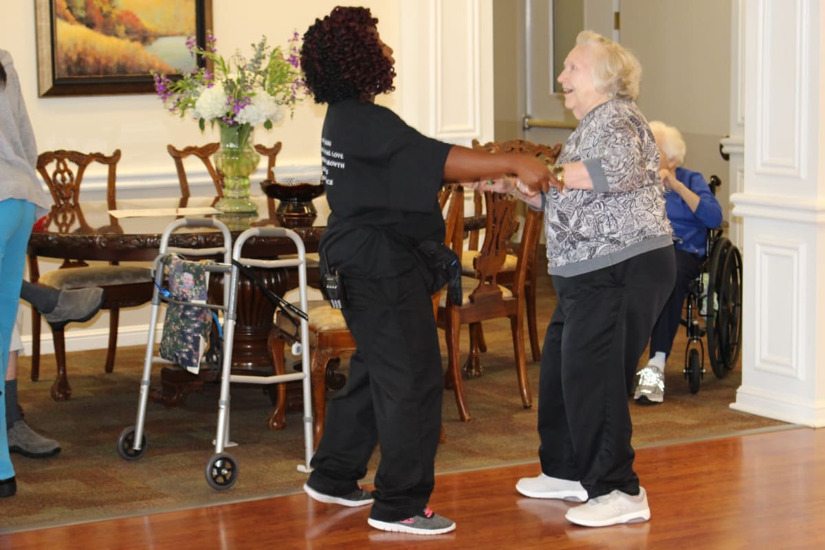 Resident dancing with care worker at Parsons House Frisco in Frisco, Texas
