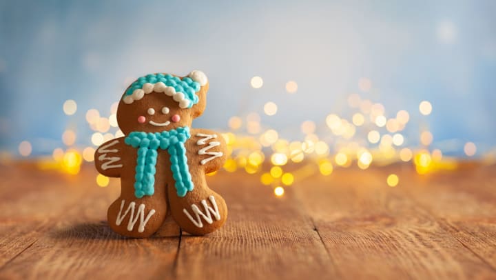 Cute gingerbread man standing in front of some lights
