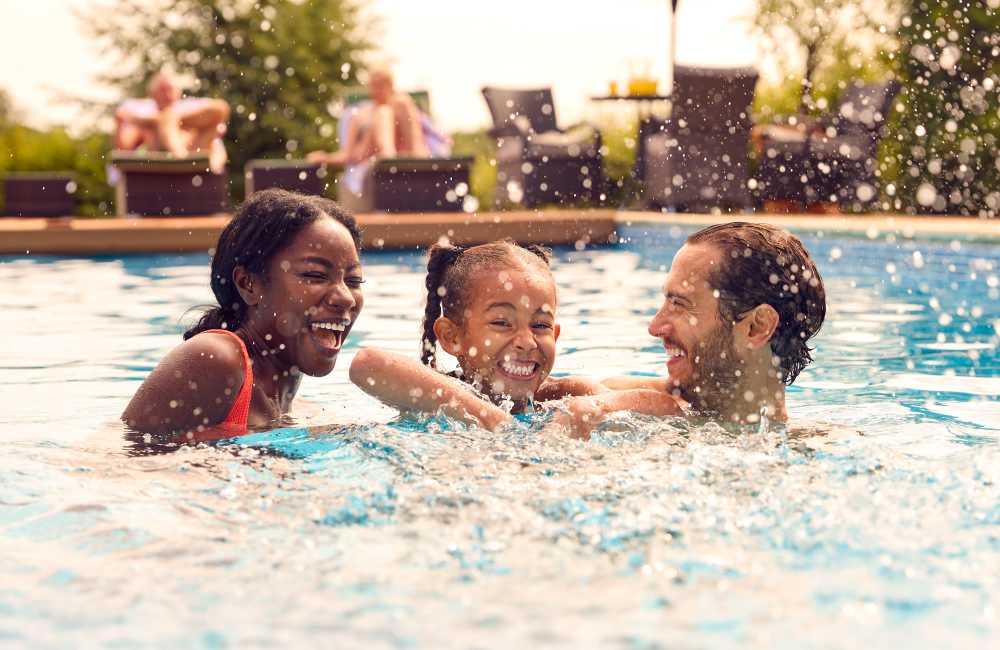 Happy family enjoying their time in the resort-style swimming pool atBlankenbaker Crossings in Louisville, Kentucky