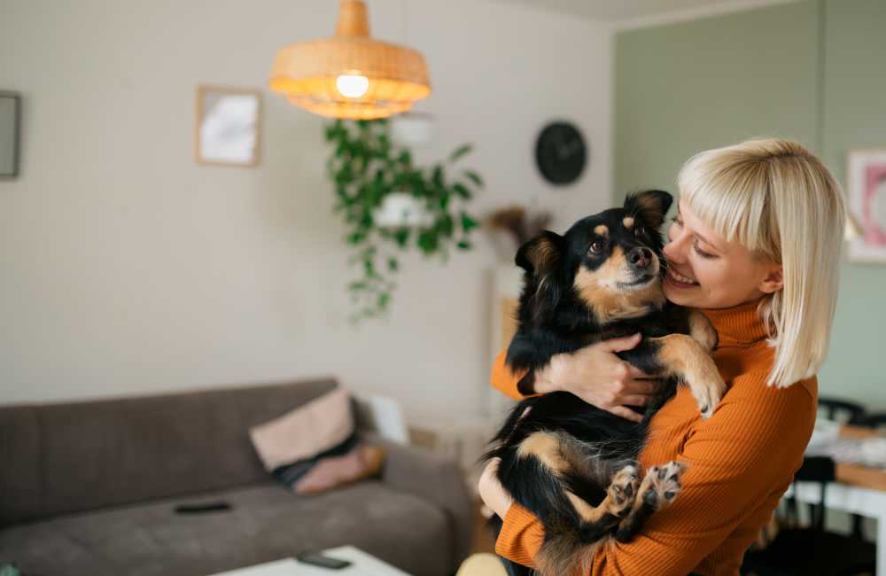 Woman with her dog in apartment at Echelon Park Apartments in Mcdonough, Georgia